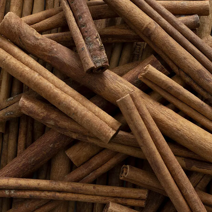 A close up of cinnamon sticks on top of a table.