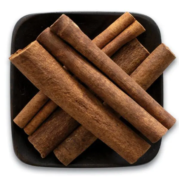 A black plate with some cinnamon sticks on it
