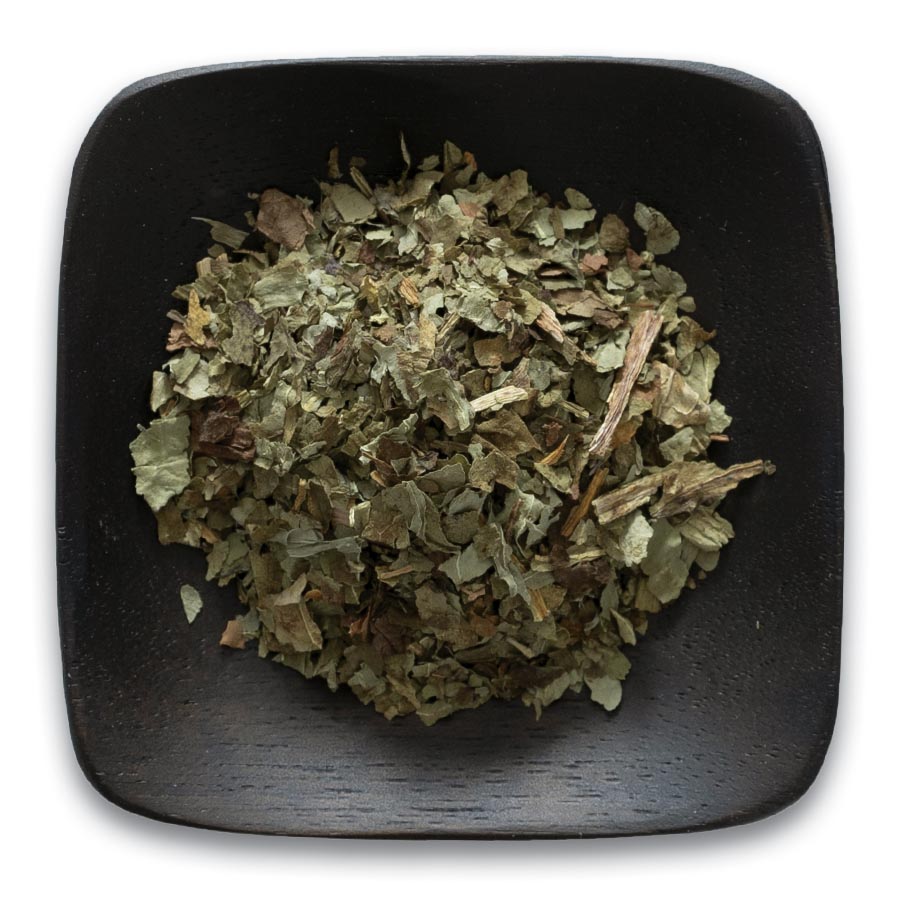A bowl of dried herbs on top of a table.